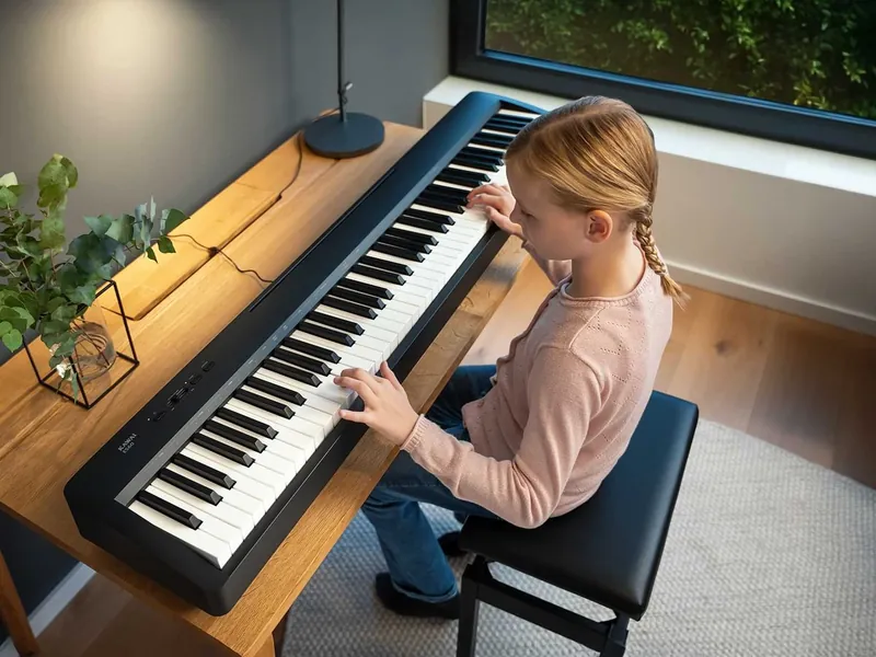 A girl practicing on a Kawai ES60 digital piano at a wooden desk