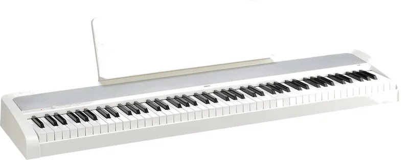 White Korg B2 digital piano with its music stand